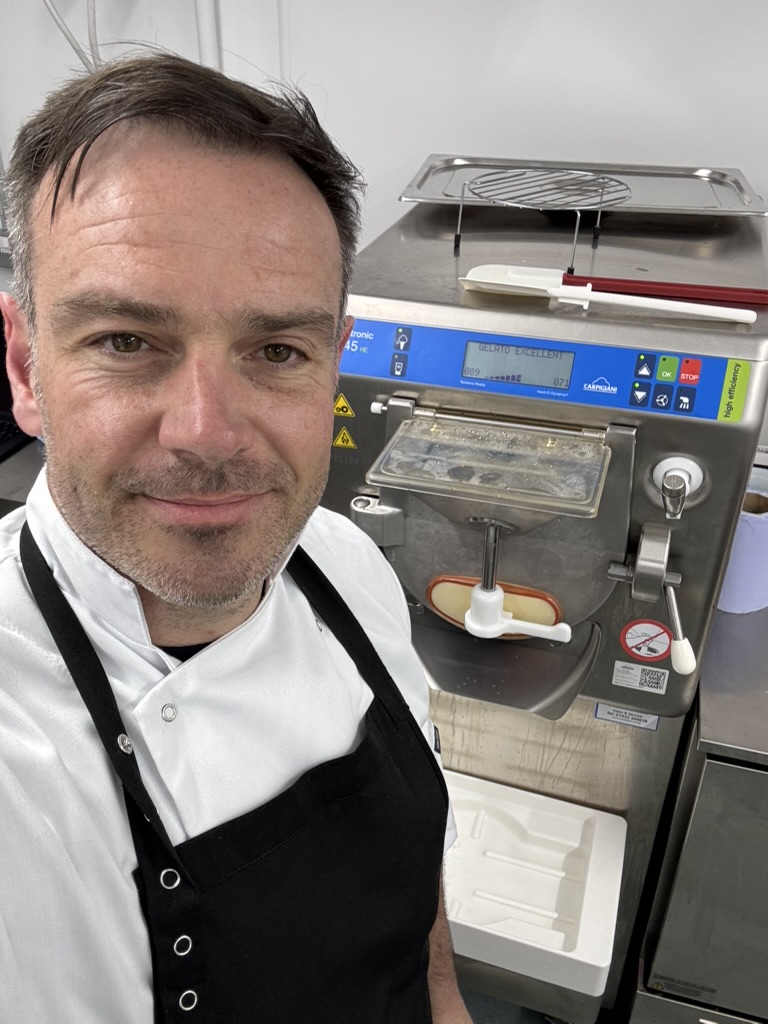 Antonio De Roma in the production kitchen with a gelato machine