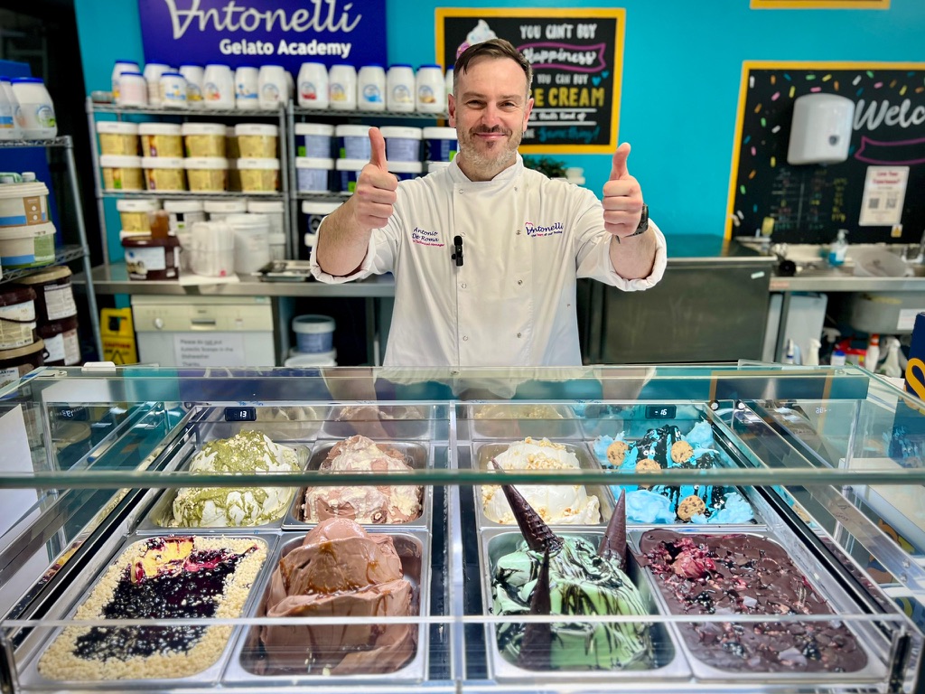 Antonio De Roma behind a fully stocked gelato counter